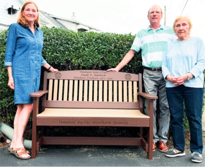 Catherine, Joseph and Nancy Needham are shown with the bench dedicated to Joseph P. Needham.